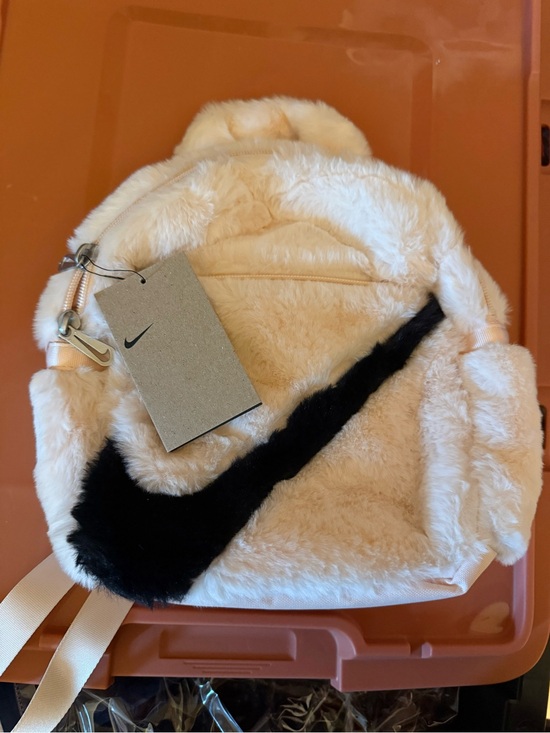 Nike Handbags - Nike Cream Faux-Fur Backpack with Black Swoosh Accent